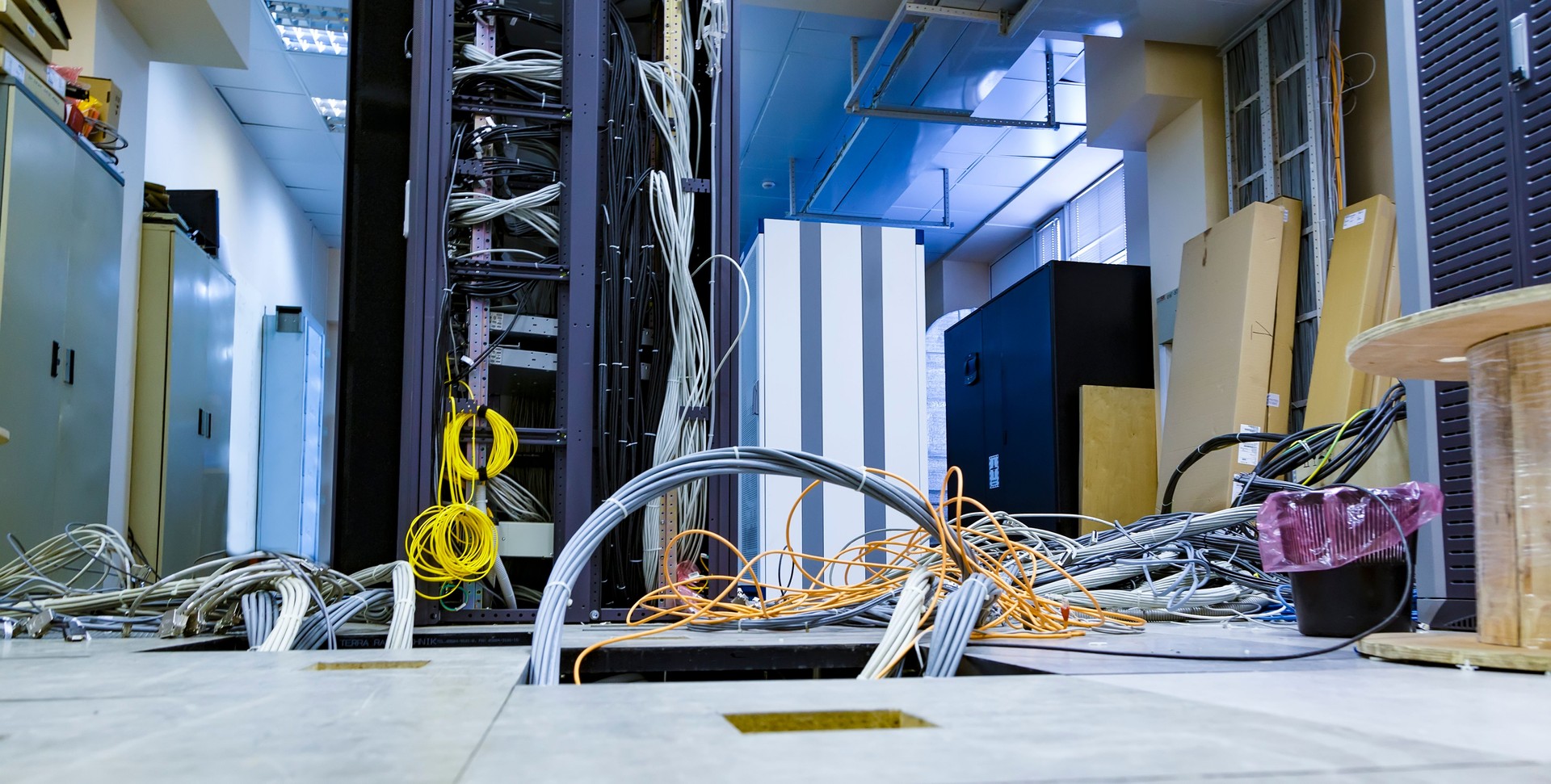 Raised floor and suction tool in modern interior of server room in datacenter